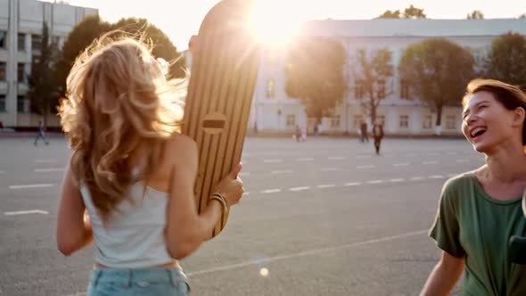 Two Fashion Hipster Girls at Outdoors Summer Party Pretty Teenage Friends with Skateboard in alt