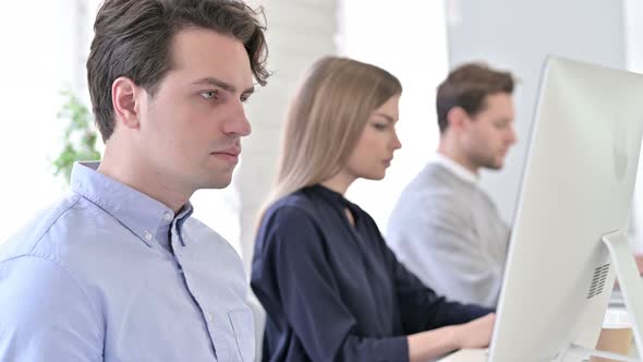 Startup Team Using Desktop in Modern Office alt