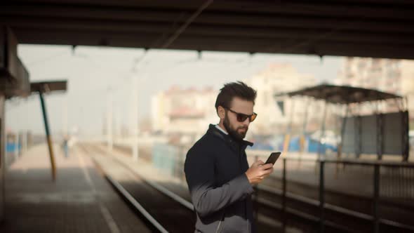 Man Passenger Looking On Phone And Wait Public Transport. Businessman Hurries To Work. alt