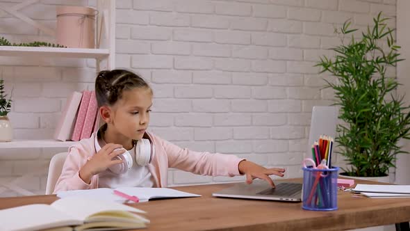 Child Girl Have Video Call with Teacher Using Laptop for Studying Online