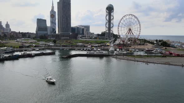 Aerial shot of alphabetic tower, skyscrapers and embankment of beautiful city of Batumi, Georgia alt