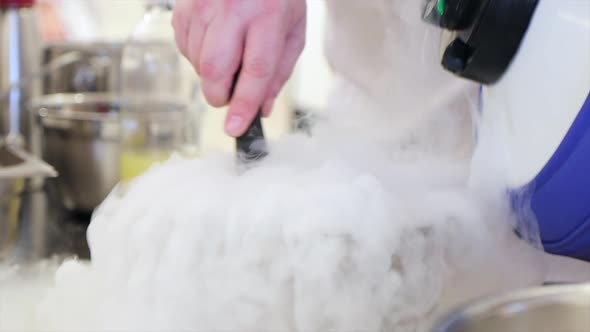 Professional Chef is Mixing Ingredients with Liquid Nitrogen in Steel Bowl