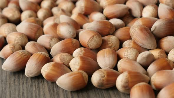 Whole organic hazelnuts on the table close-up 4K 2160p 30fps UHD tilting footage - Heap of Corylus a alt