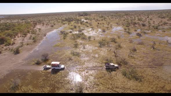 Two Expedition Vehicles Passing Through Water