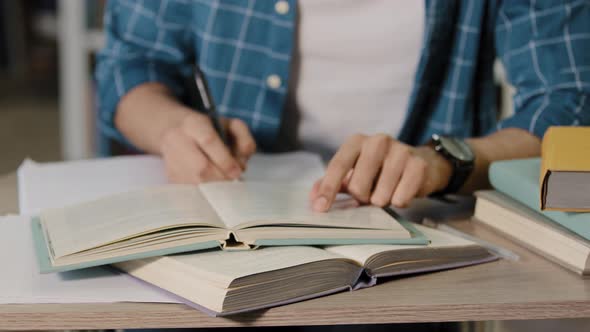 Closeup Male Hands Unrecognizable Young Male Student Sitting in Library Doing Homework Preparing alt
