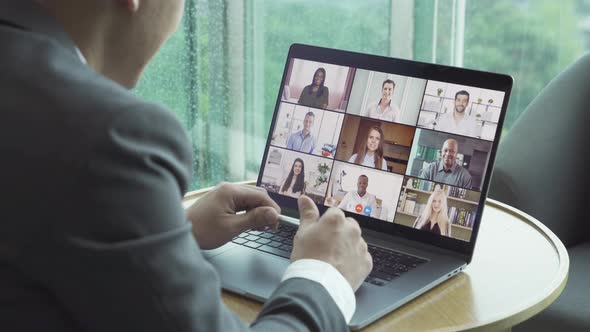 Asian man talking to multi ethnic group of business people working from home and office, talking alt