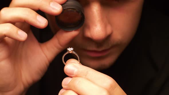 Appraiser Checks Diamond in Ring