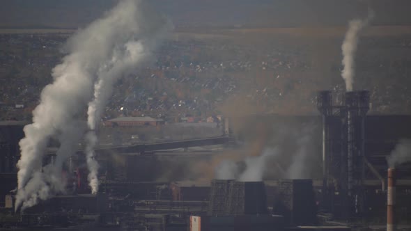 large amount of smoke and soot is emitted from the factory pipes of the metallurgical plant alt
