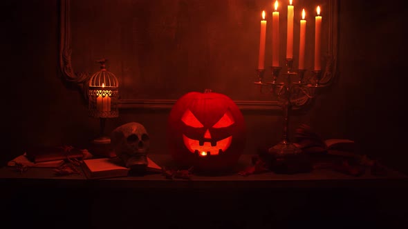 Scary laughing pumpkin and an old skull over the frightening gothic background. alt