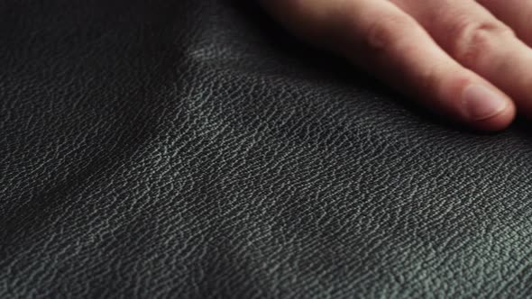 Touching Black Leather with Hand Closeup Production Handmade Accessories Made of Genuine or alt