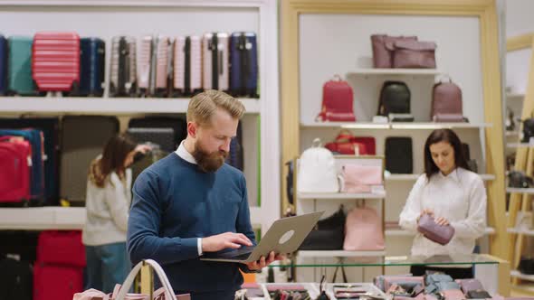 Good Looking Man Supervisor Using Laptop to Verify alt