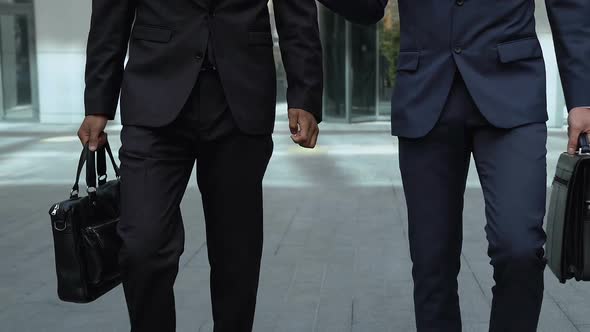Busy Men Walking Together Near Office Building, Lawyer or Members of Commission alt
