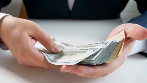 Closeup  Footage of Businessman Holding and Playing with Big Stack of Money alt