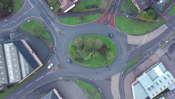 Aerial view of traffic on a roundabout with roads and cars in England