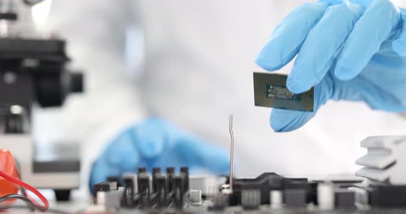 Repairman Installing Computer Processor Into Motherboard Closeup  Movie Slow Motion alt