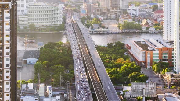 Bangkok traffic on Taksin bridge over Chao Phraya river in morning - time lapse