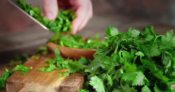 Men Hands Put Chopped Parsley on a Plate alt