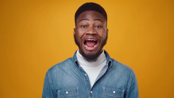 Amazed African American Man Shocked Yellow Background alt