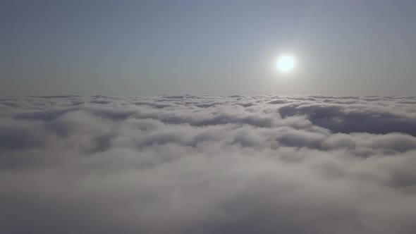 View From a Drone on a Sea of Clouds to the Horizon at Dawn alt