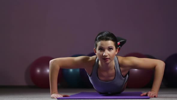 Successful Goal-Oriented Young Woman Doing Knee Push-Ups With Smile on Face alt
