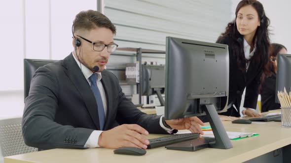 Business People Wearing Headset Working in Office alt