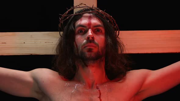 Jesus Christ Suffering Agony in Red Lights, Blood and Tears on Body, Crucifixion alt