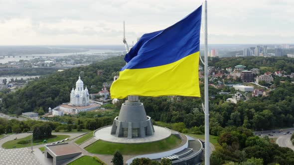 Aerial Top View of Kiev Motherland Statue Monument and National Ukrainian Flag Fluttering on alt