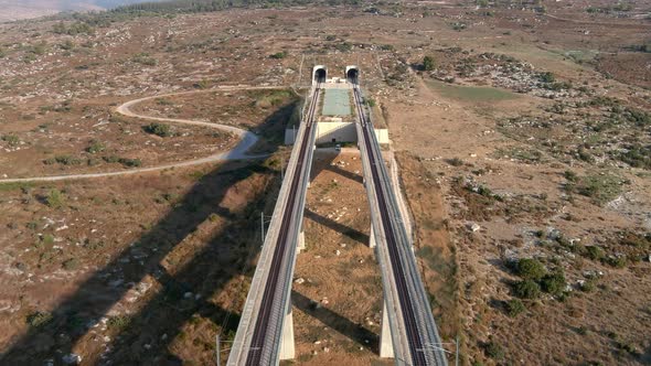 Tall train bridges in the Judea valleys of Israel, aerial drone view alt