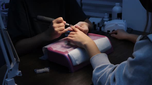 Anonymous Beautician Doing Manicure to Female Client