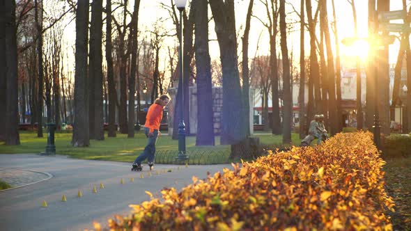 Professional Bearded Roller Conducts Daytime Training in an Autumn City Cozy Park, Makes Complex alt