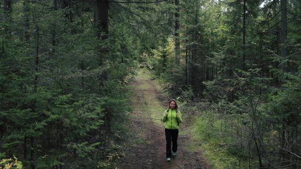 Woman tourist walking through the forest