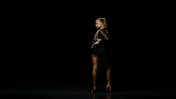 Professional Beautiful Dancer Cha-cha-cha in a Studio on a Dark Background alt