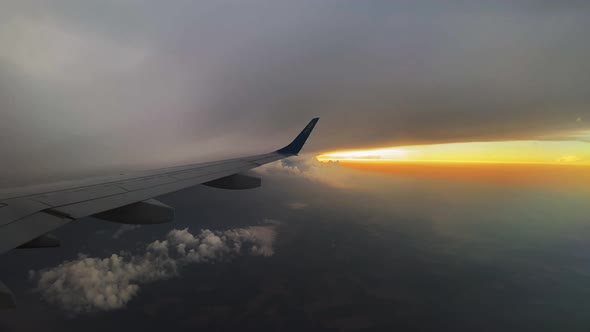 View of the Red Sunset Sky From the Window of a Passenger Plane