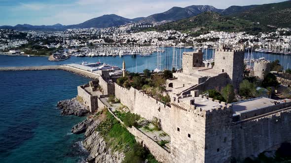 Amazing panoramic view from drone of full of yachts Bodrum harbour and ancient Kalesi castle. alt