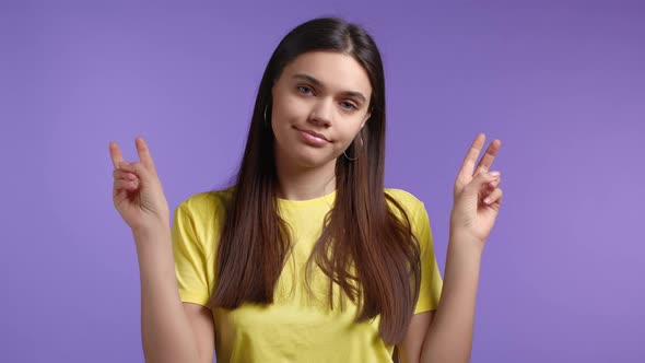 Pretty Woman Showing with Hands and Two Fingers Air Quotes Gesture Bend Fingers Isolated Over Violet alt
