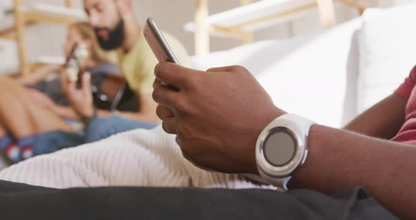 Man using smart phone while sitting on the couch alt