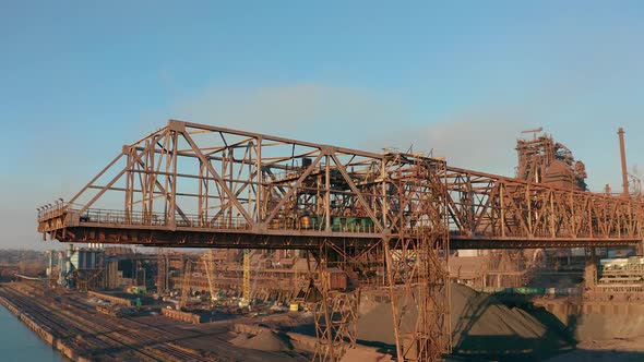 Cranes for Loading at an Industrial Plant Standing at Sea alt