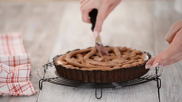 The Pastry Chef Makes Chocolate Almond Tart with Cream. alt