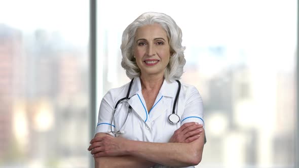 Portrait of Female Doctor on Blurred Background. alt