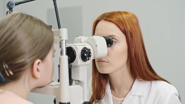 Pediatric Optician Checking Eyes of Girl alt