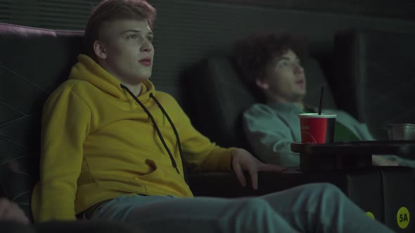 Scary Movie in a Cinema Two Friends Watching a Horror Movie on a Big Screen a Scary Moment Reaction alt