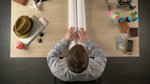 Male Unfolding World Map to Choose Country for Travel Destination, Vacation alt