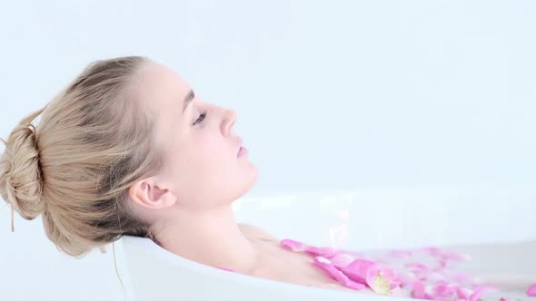 Beautiful Sexy Caucasian Blonde Girl In Bikini Lying In Flower Bath In Resort Day Spa Salon alt