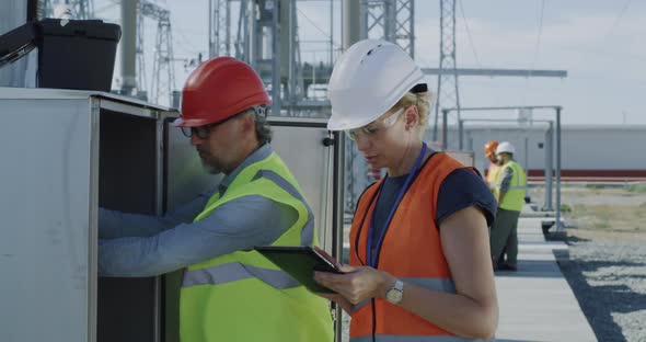 Engineers Checking Transformer Box on Power Plant alt
