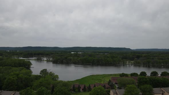 View over residential housing neighborhood to the Mississippi River on cloudy day.