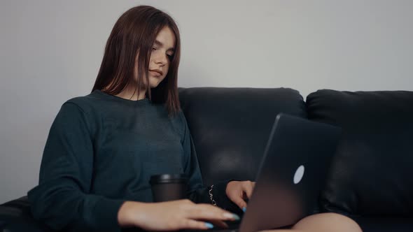 The Redheaded Journalist Works at Home on a New Article Taps Stops Thoughtfully and Then Taps Again alt