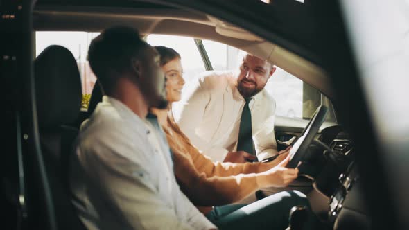 African American Man and His Caucasian Woman Visiting Dealership Center for alt
