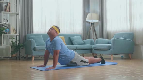 Fat Asian Man Doing Yoga By Upward Facing Forward Bend On Mat At Home alt