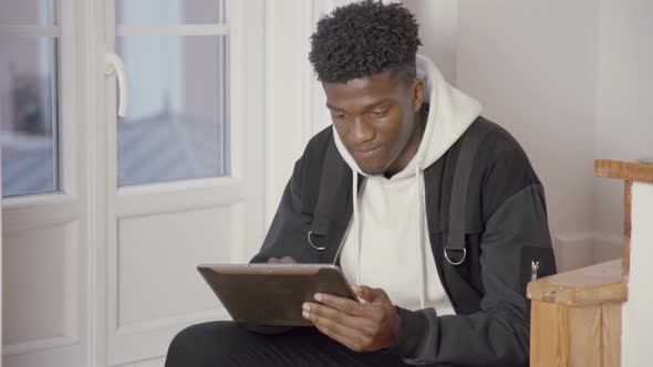 Portrait of Smiling Young Man Communicating in Online Chat alt