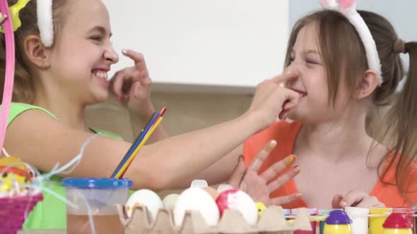 The Two Girls Paint on Each Other Faces and Laugh